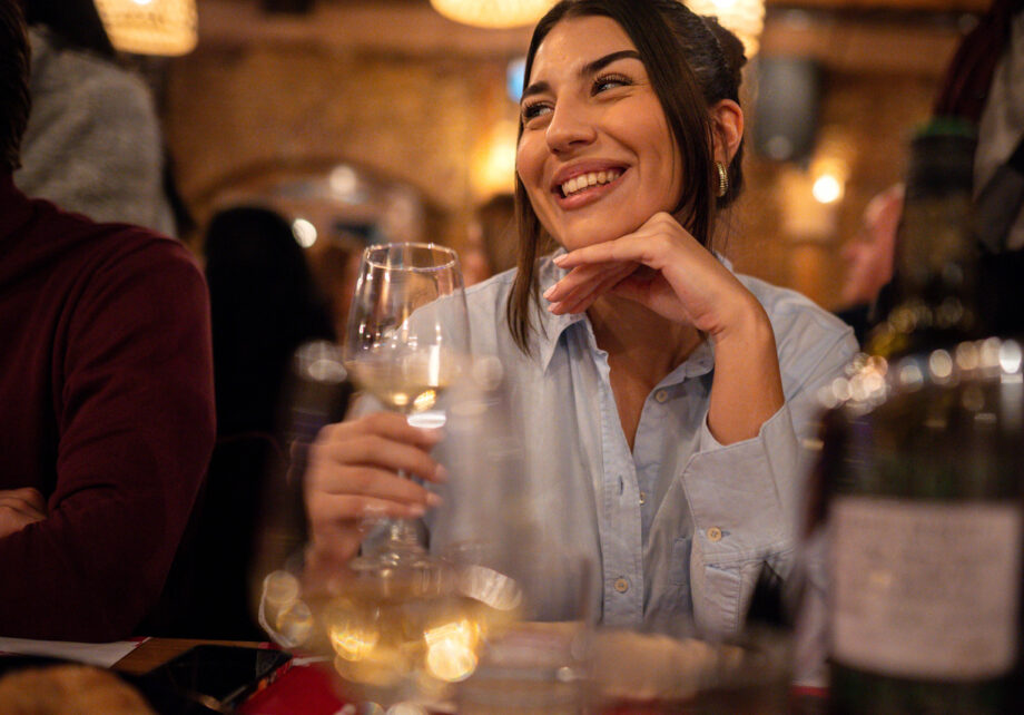 Young smiling woman enjoying a lovely night at the restaurant